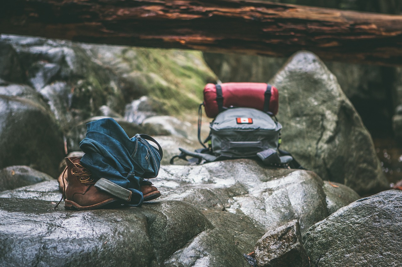 outdoor survival gear placed on large rocks outside