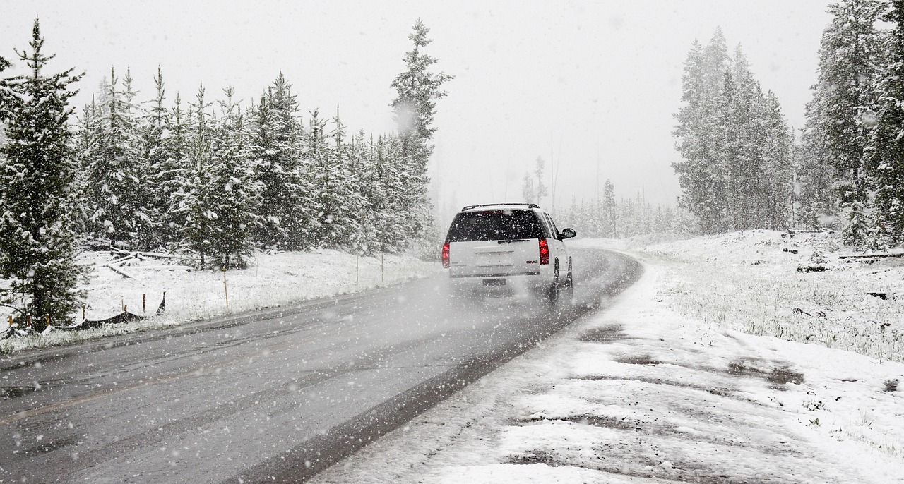 driving down an icy snowy road with Emergency Items To Keep In Your Vehicle