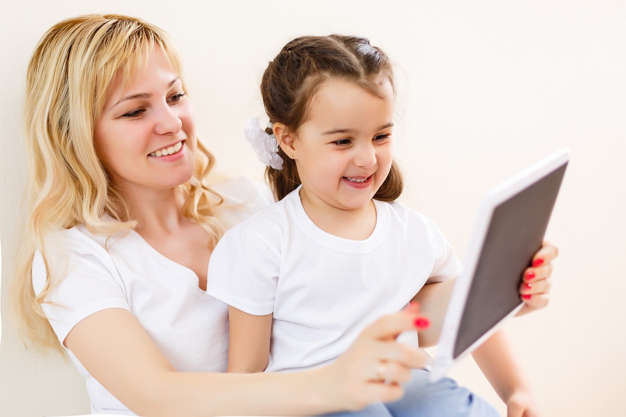 mother and daughter practicing online safety best practices using a tablet